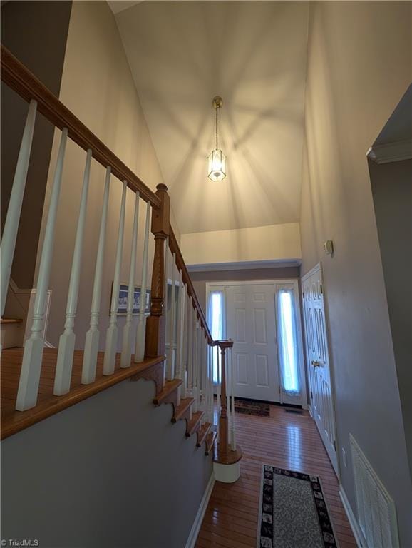 entryway featuring a high ceiling and hardwood / wood-style floors