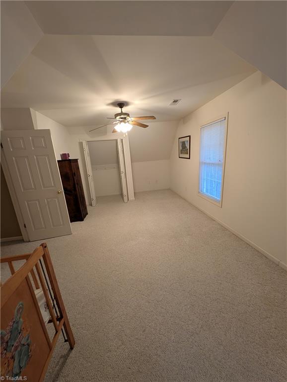 bonus room featuring carpet floors, lofted ceiling, and ceiling fan