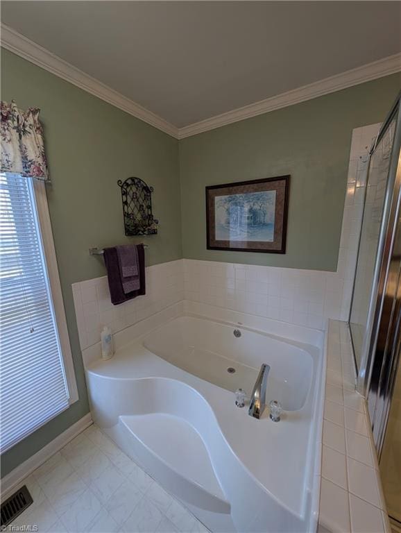 bathroom featuring a bath and crown molding