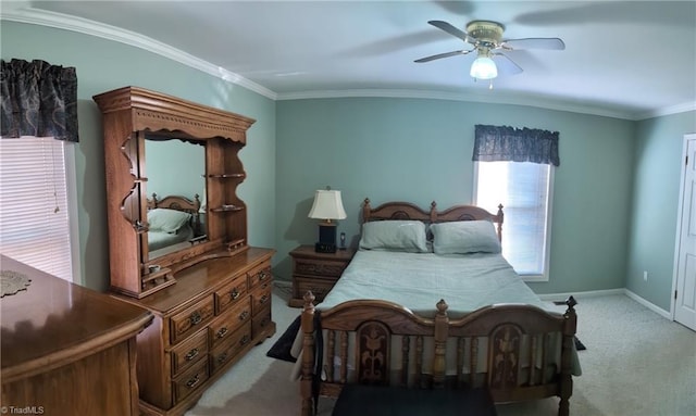 bedroom featuring ceiling fan, ornamental molding, and light colored carpet