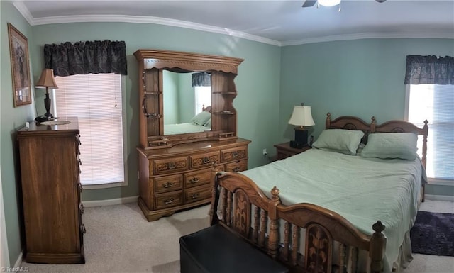 carpeted bedroom with ceiling fan and ornamental molding