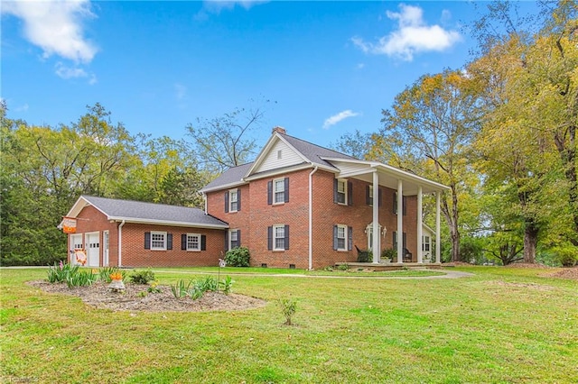 rear view of property with a garage, a lawn, and a porch