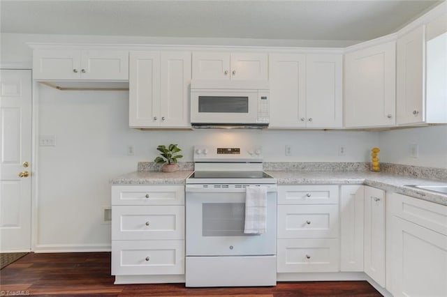 kitchen featuring white appliances, white cabinetry, and dark hardwood / wood-style flooring