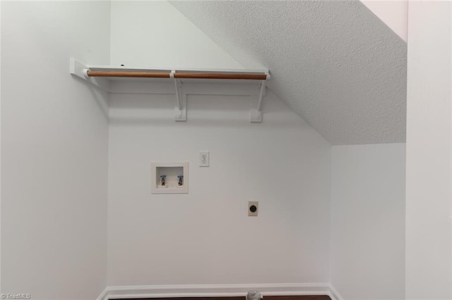 clothes washing area with hookup for a washing machine, wood-type flooring, a textured ceiling, and electric dryer hookup