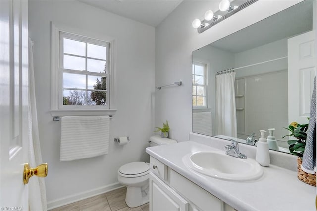 bathroom featuring toilet, curtained shower, vanity, and tile patterned floors