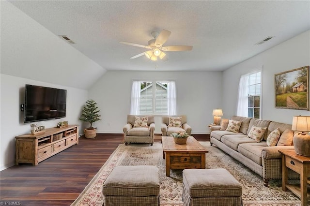 living room featuring a textured ceiling, dark hardwood / wood-style flooring, ceiling fan, and vaulted ceiling