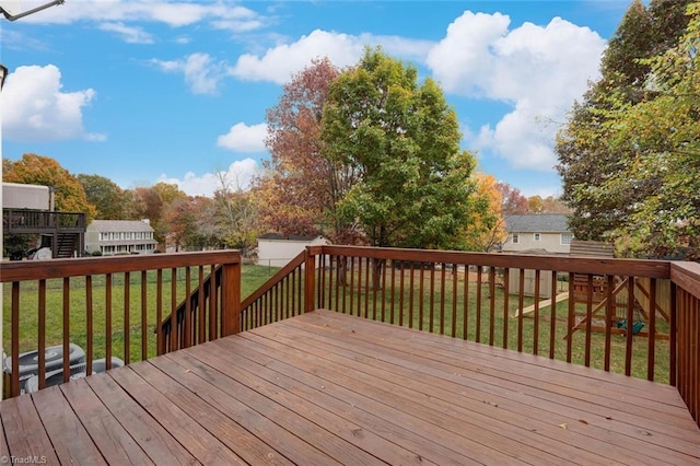 deck featuring a storage shed and a yard