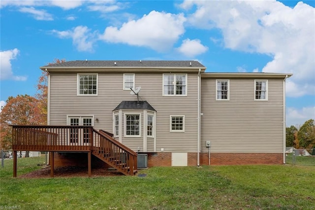 back of property with a lawn and a wooden deck