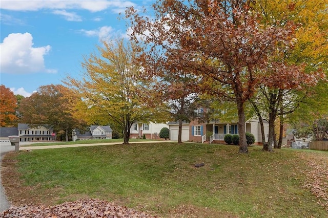 obstructed view of property with a front yard