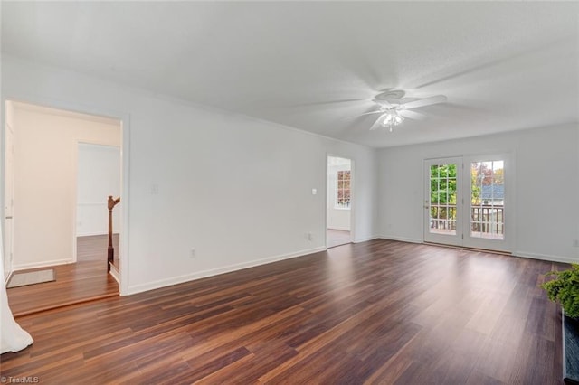 spare room with dark wood-type flooring and ceiling fan