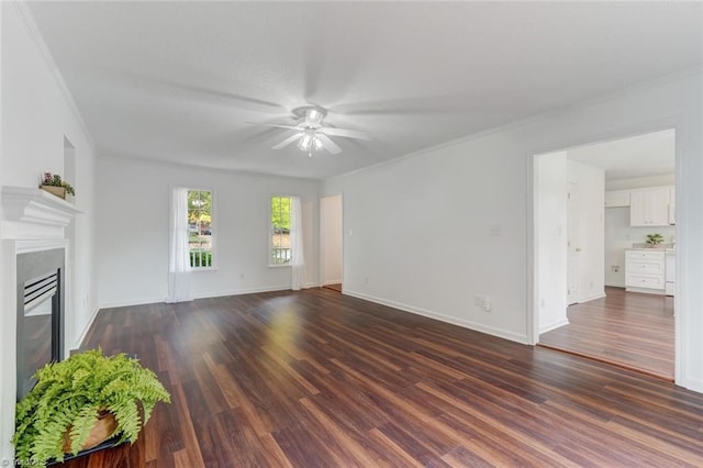 unfurnished living room with ornamental molding, ceiling fan, and dark hardwood / wood-style floors