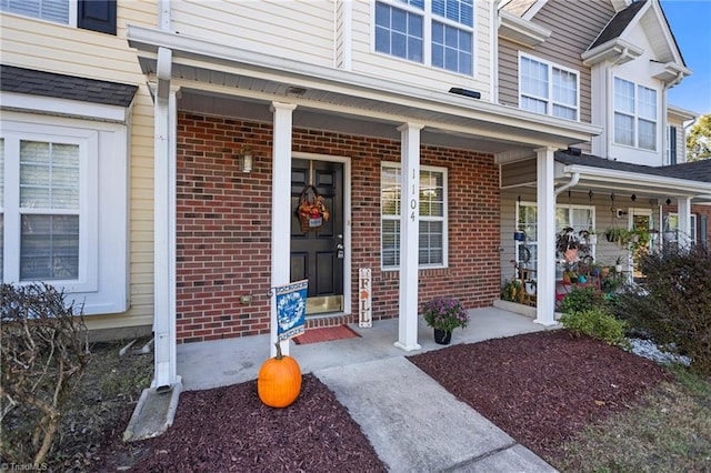 view of exterior entry with a porch