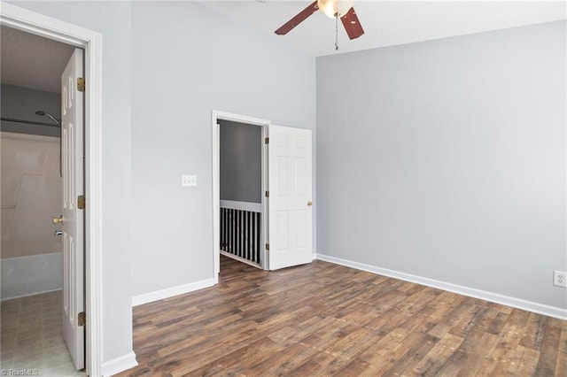 unfurnished bedroom featuring dark wood-type flooring and ceiling fan