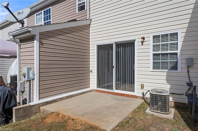 entrance to property with central AC unit and a patio area