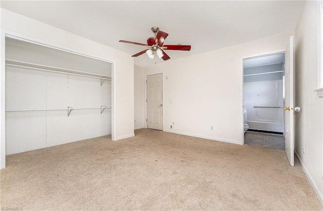 214 Whispering Creek Rd, King, NC 27021 - unfurnished bedroom featuring carpet flooring, connected bathroom, a closet, and a ceiling fan