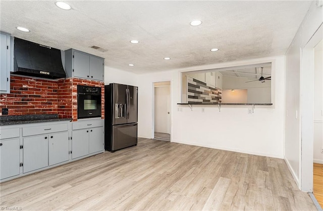 214 Whispering Creek Rd, King, NC 27021 - kitchen with black appliances, ventilation hood, light wood-style floors, dark countertops, and recessed lighting