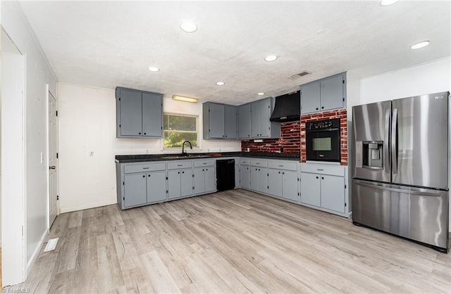 214 Whispering Creek Rd, King, NC 27021 - kitchen featuring black appliances, dark countertops, ventilation hood, gray cabinetry, and light wood-style flooring