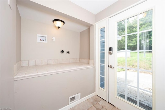 doorway featuring light tile patterned flooring