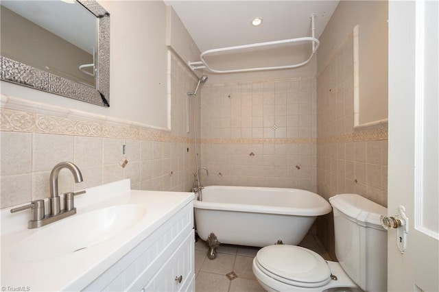 bathroom featuring tile patterned flooring, vanity, tile walls, and toilet