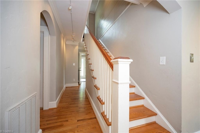 hall featuring crown molding and light hardwood / wood-style flooring