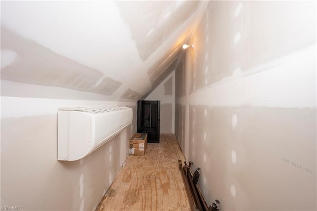 additional living space with lofted ceiling and light hardwood / wood-style flooring