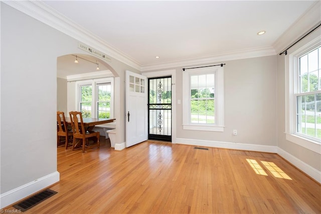 interior space featuring ornamental molding and light hardwood / wood-style floors