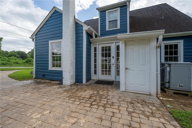 rear view of property featuring central AC and a patio