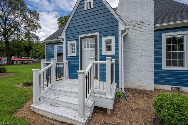 property entrance with a yard