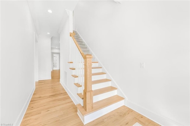 staircase with hardwood / wood-style floors