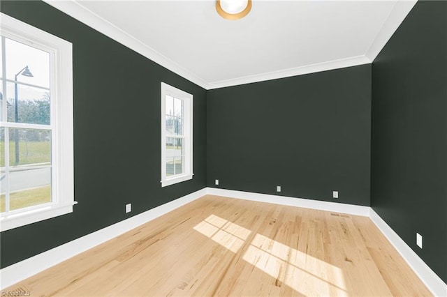 unfurnished room featuring hardwood / wood-style floors and crown molding