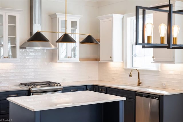 kitchen with stainless steel appliances, sink, white cabinets, and blue cabinetry