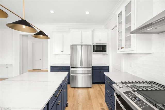 kitchen featuring blue cabinetry, wall chimney exhaust hood, white cabinets, and stainless steel appliances