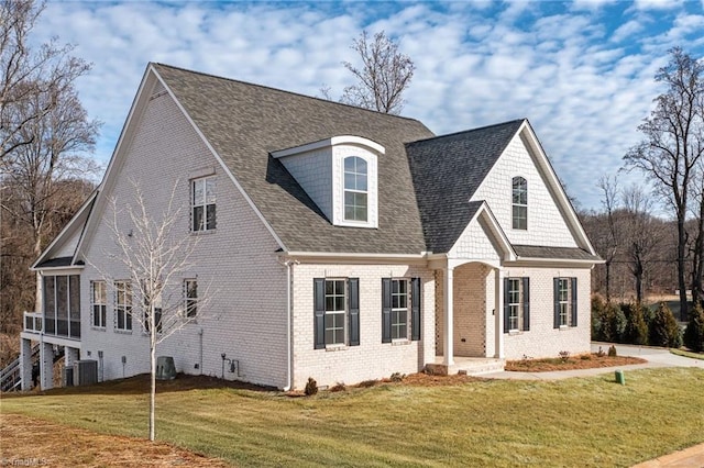 view of front of house featuring a sunroom and a front yard