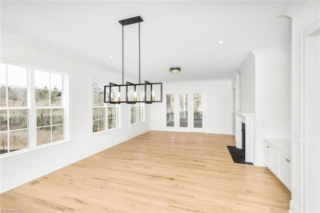 interior space with crown molding, a chandelier, and light wood-type flooring