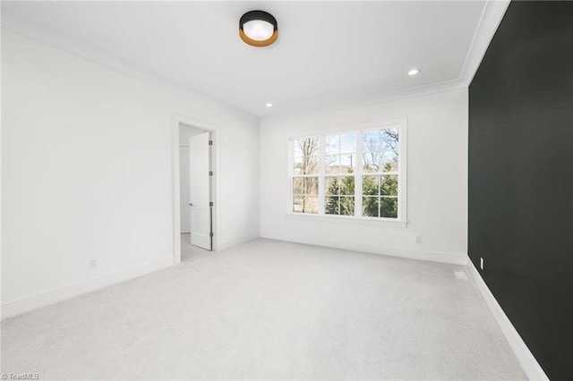 carpeted empty room featuring ornamental molding