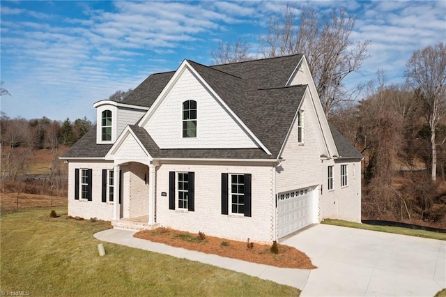 view of front of house featuring a garage and a front lawn