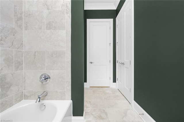 bathroom with crown molding and tiled shower / bath combo