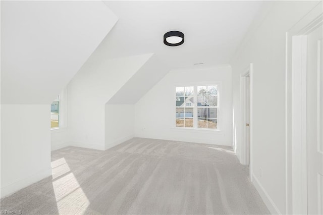 bonus room featuring light carpet and lofted ceiling