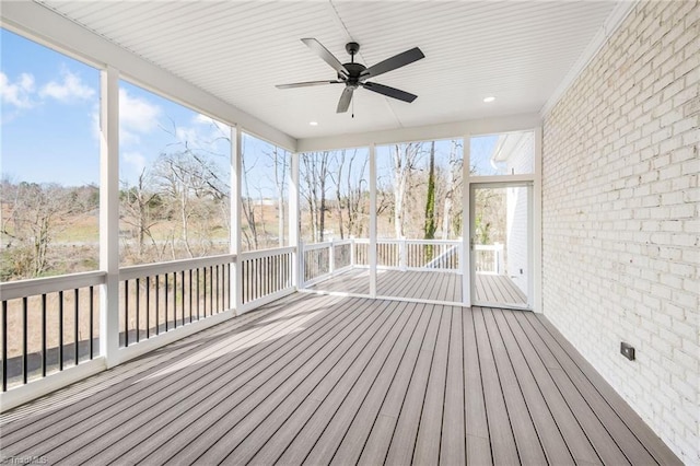 unfurnished sunroom featuring ceiling fan