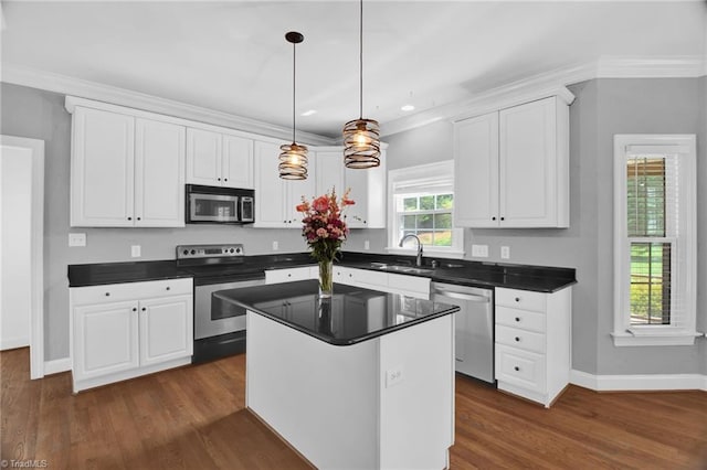 kitchen featuring appliances with stainless steel finishes, white cabinets, baseboards, dark countertops, and recessed lighting