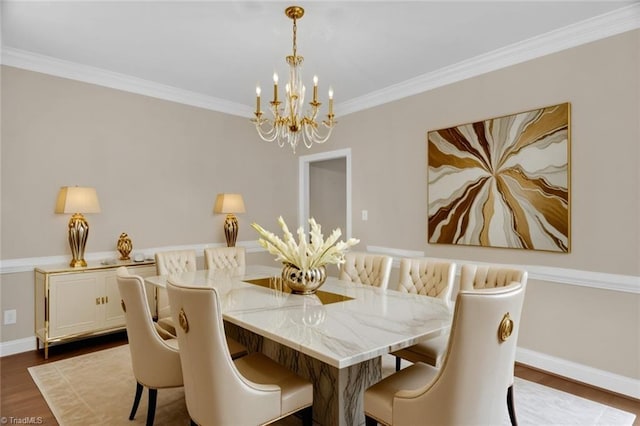 dining room with a chandelier, dark wood finished floors, crown molding, and baseboards