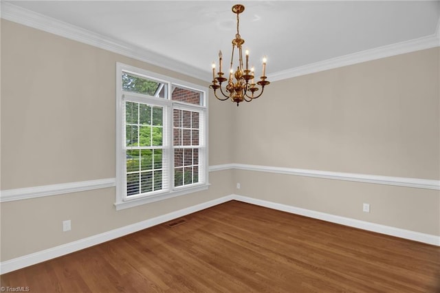 unfurnished room featuring a chandelier, baseboards, wood finished floors, and ornamental molding