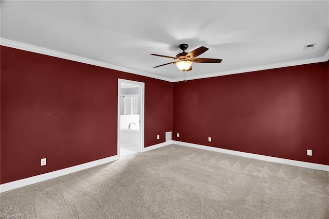 unfurnished room featuring ceiling fan, ornamental molding, baseboards, and carpet flooring