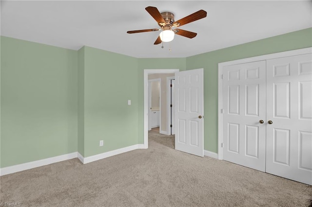 unfurnished bedroom featuring carpet floors, baseboards, a closet, and ceiling fan