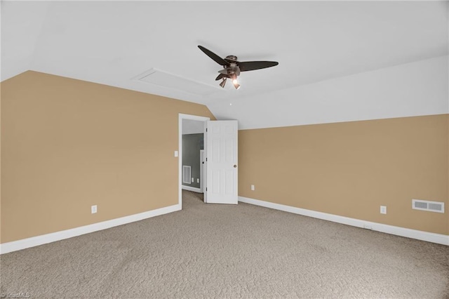 carpeted empty room with lofted ceiling, ceiling fan, and baseboards