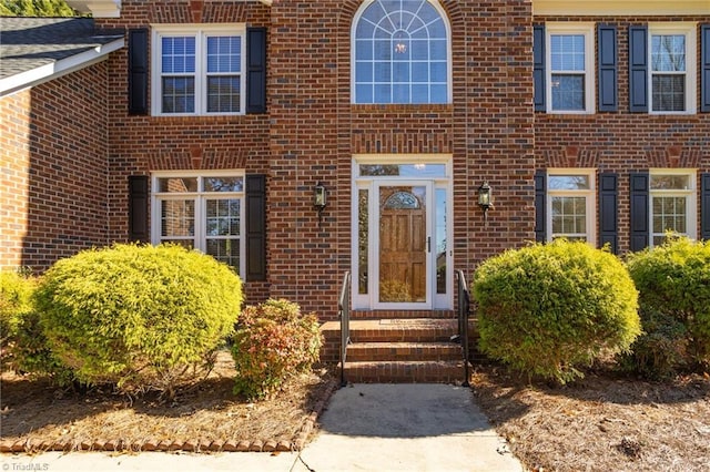 property entrance featuring brick siding