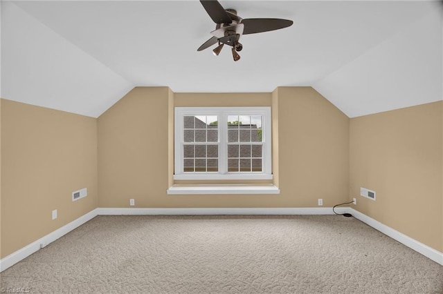 additional living space featuring vaulted ceiling, baseboards, and carpet flooring