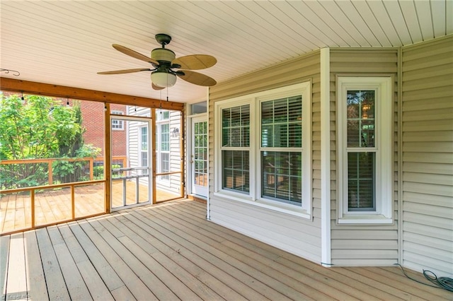 unfurnished sunroom with ceiling fan