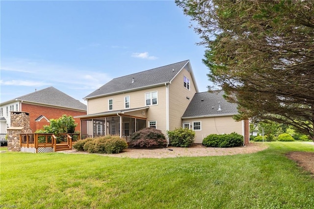 back of house with a sunroom, a wooden deck, a yard, and a shingled roof