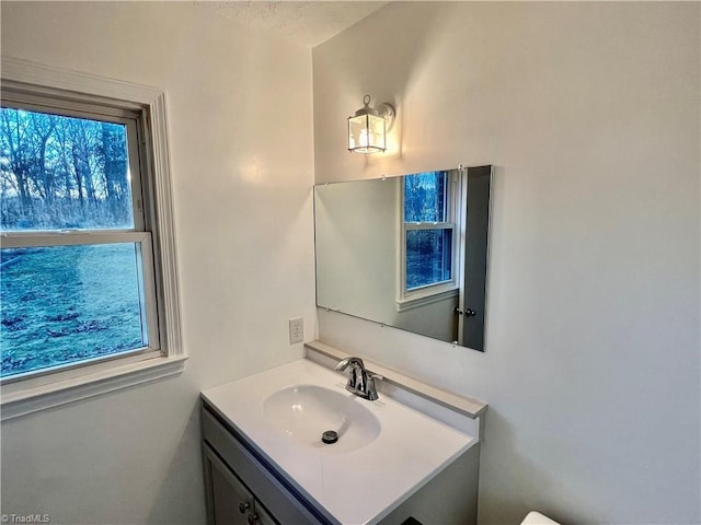 bathroom featuring vanity, plenty of natural light, and a textured ceiling